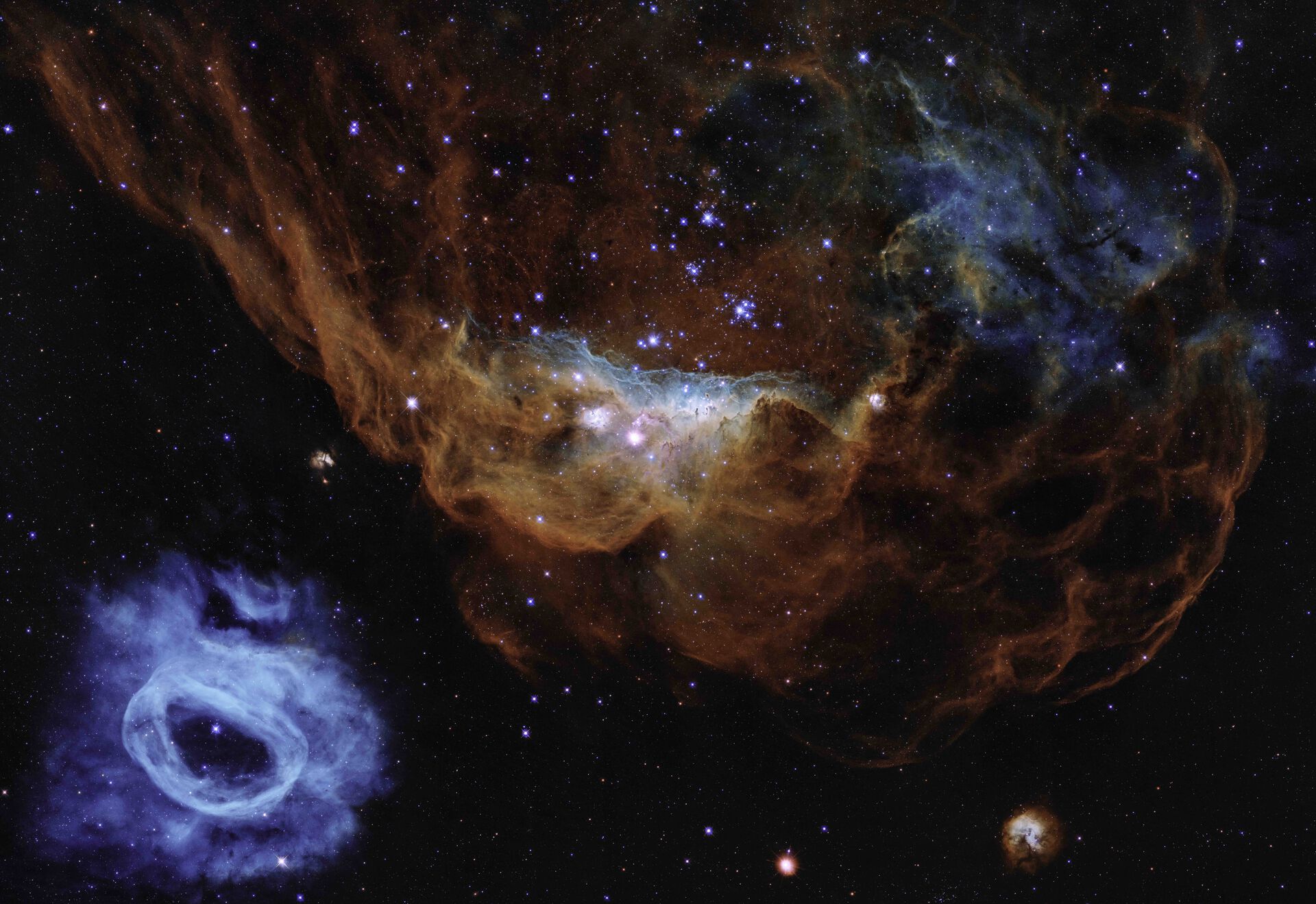 A giant nebula and a satellite galaxy of a vast star-forming region in the Large Magellanic Cloud.