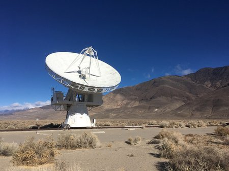 image of a radio antenna in a desert, blue sky