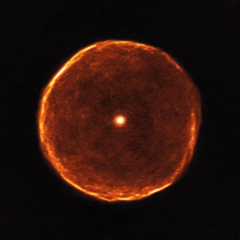 image shows an orange bubble with a star in the middle on a black background 