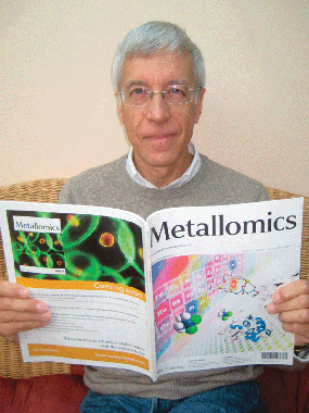 Professor Maret holding a copy of Metallomics