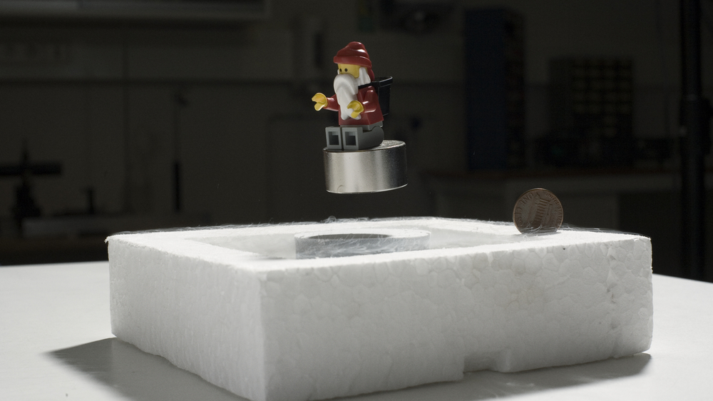 En legotrollmann på en magnet som svever over en nedkjølet superleder.