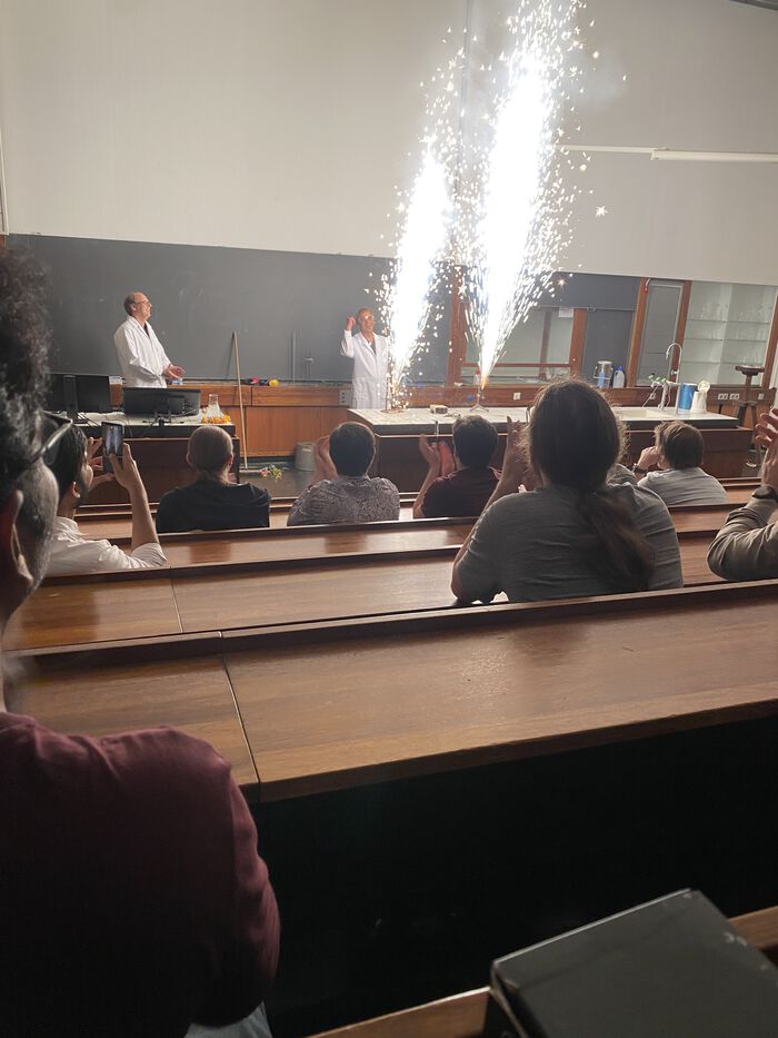 Two professors celebrating with fireworks in auditorium 1